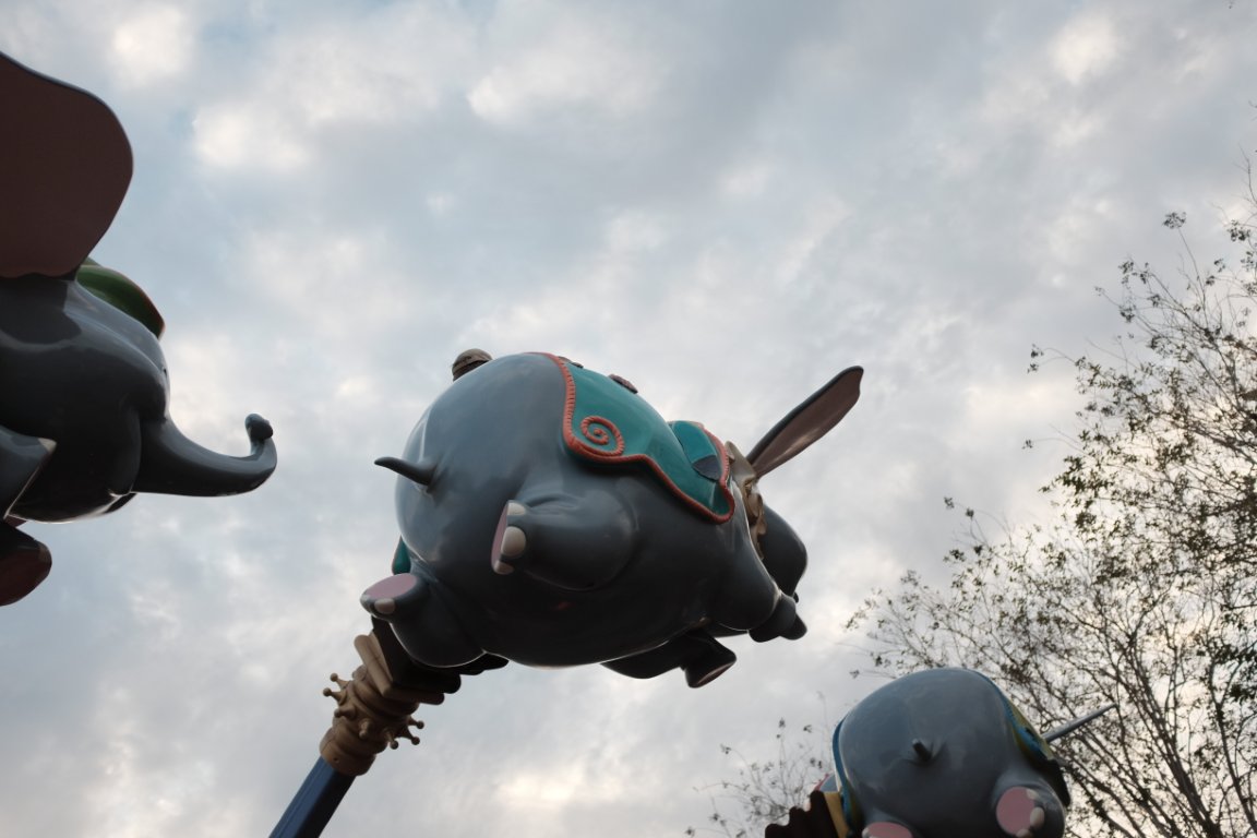 Dumbo ride elephants soaring against the sky